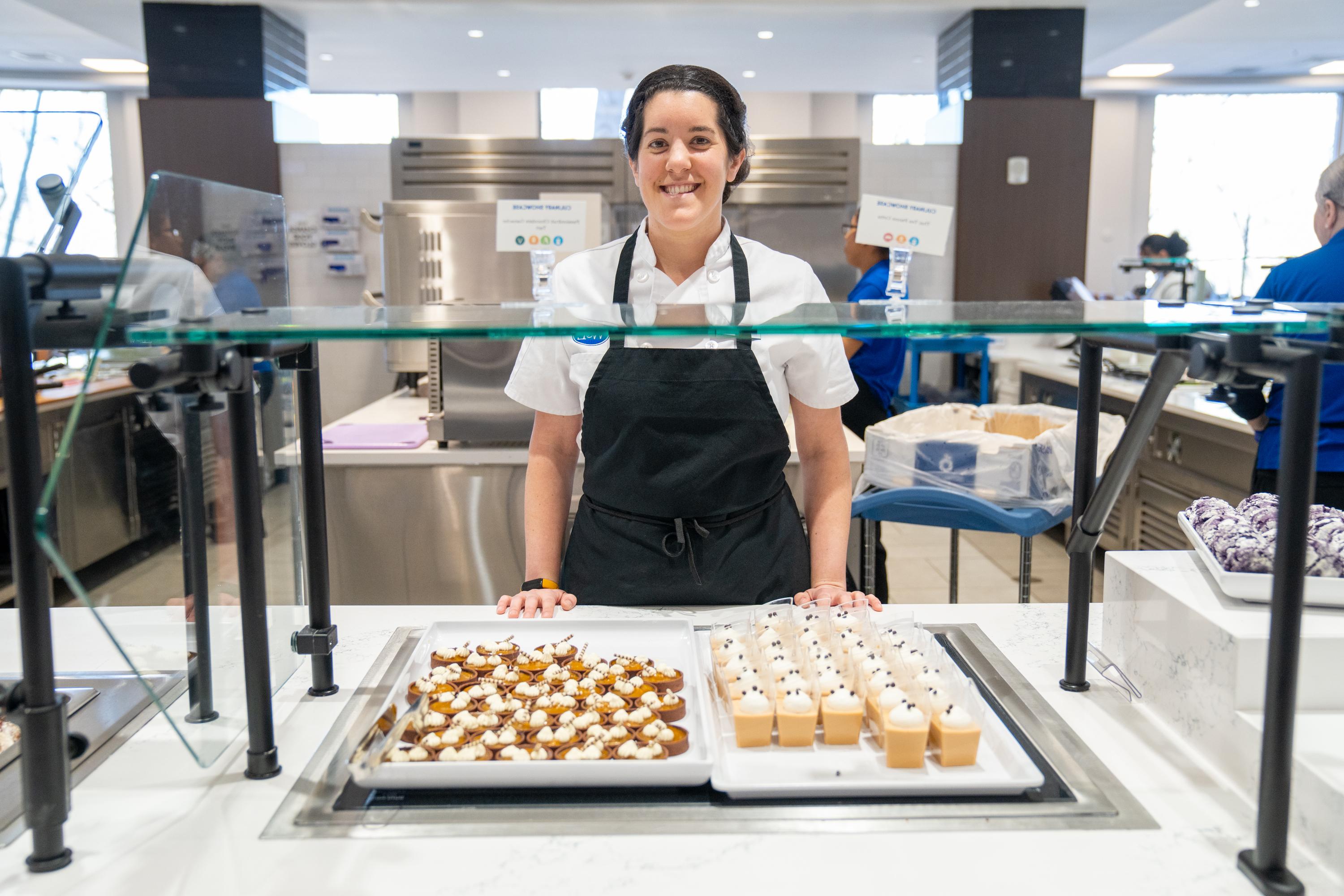 A member of Dining Services serves sweet treats